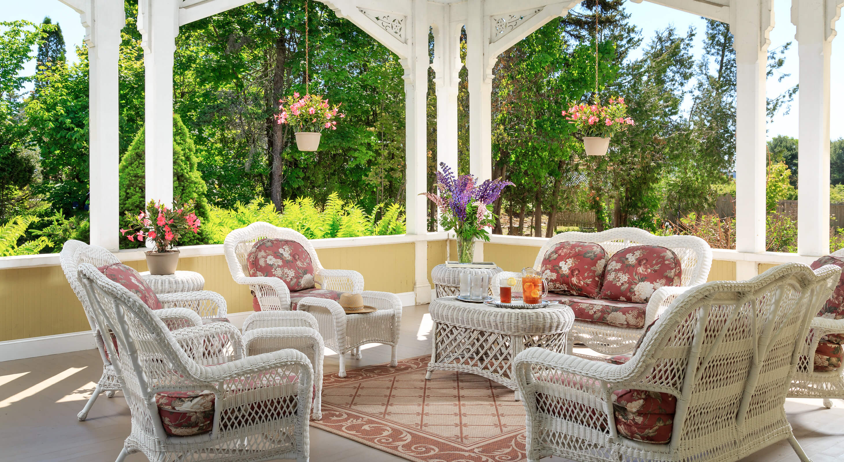 Relaxing large porch with wicker furniture