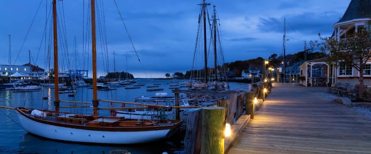 the camden marina at dusk with harbor lights glowing